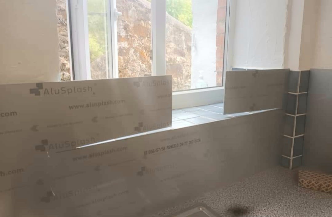 Splashback panels going up behind a sink