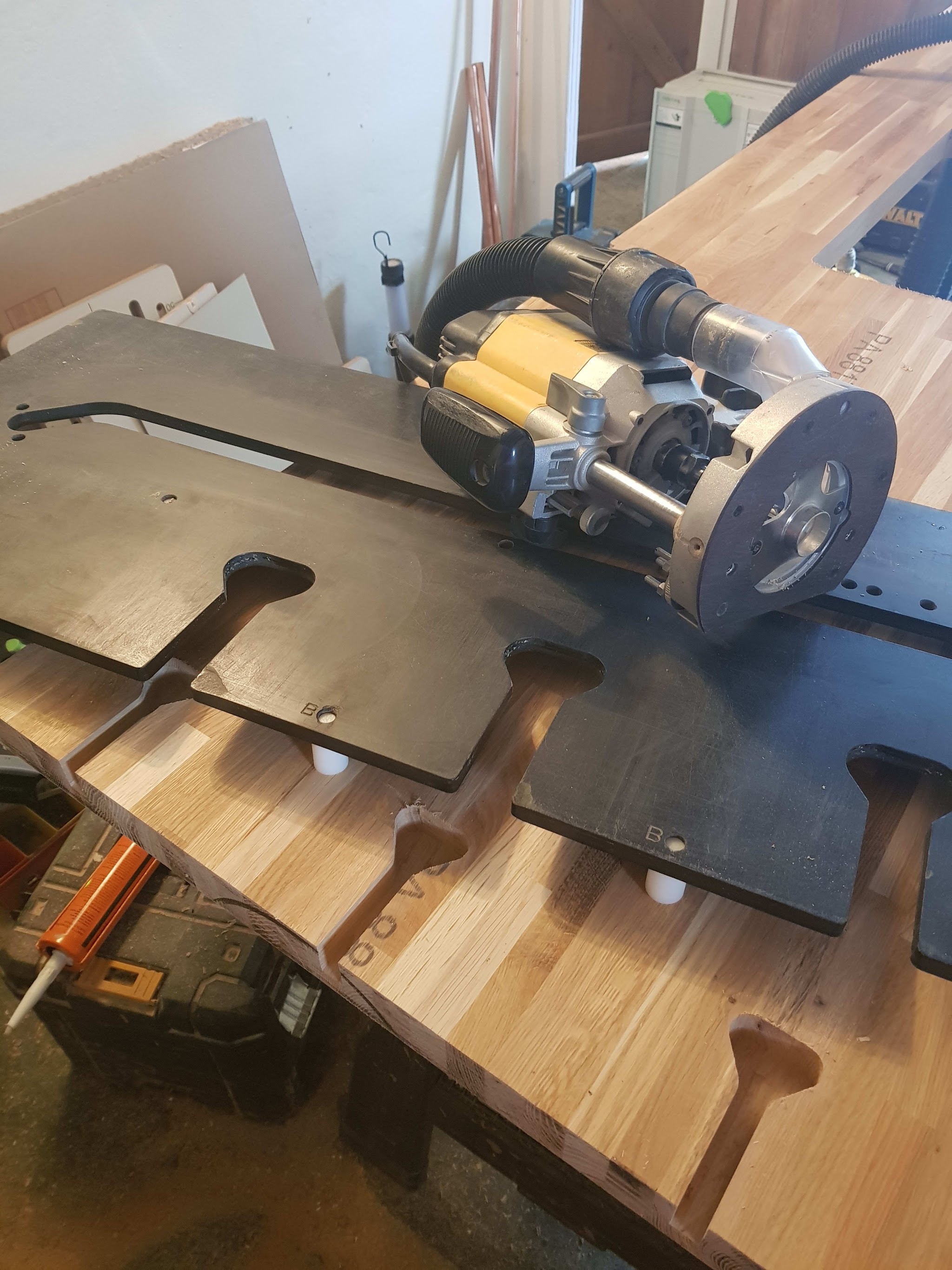 A worktop being shaped on the bench with a router